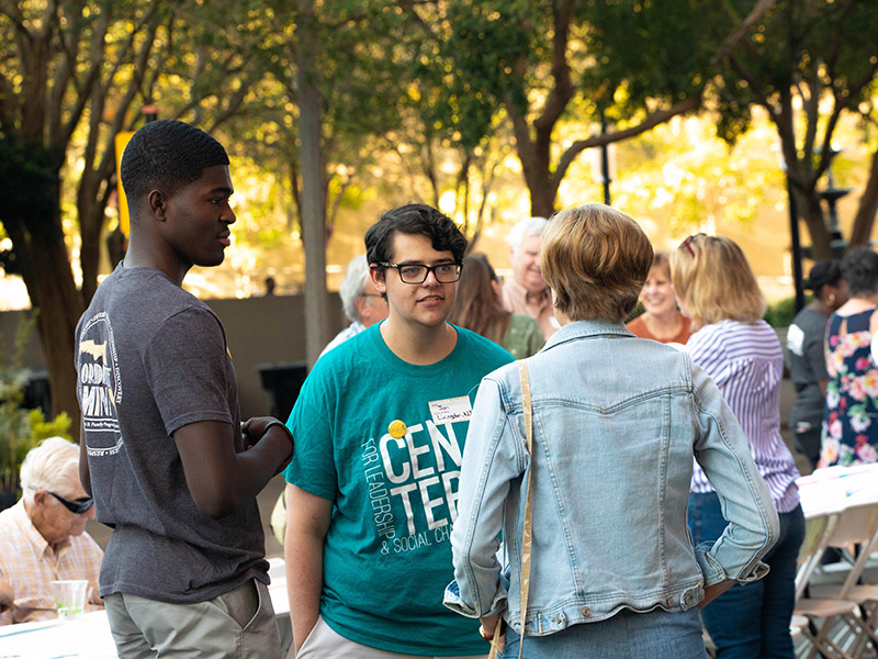 A bunch of teens hanging out at a community event