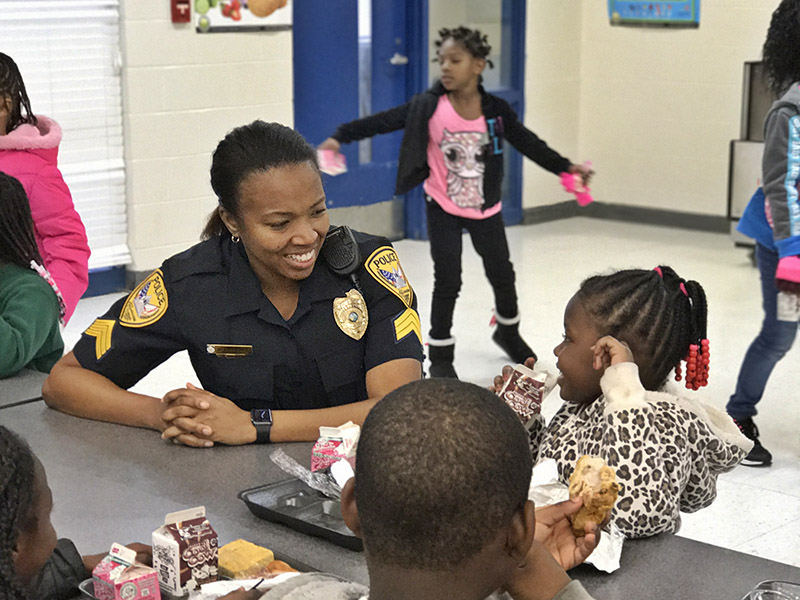 A group of kids talks to a TPD officer.